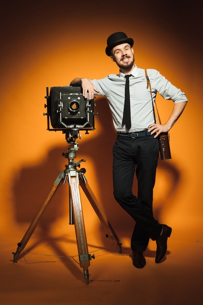 Young man with retro camera