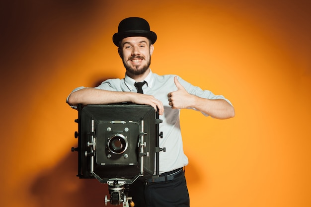 Young man with retro camera