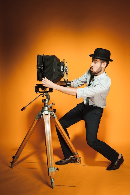 Young man with retro camera