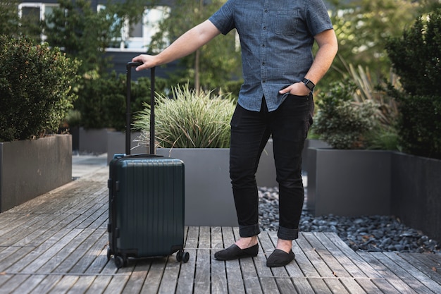 Free photo young man with a suitcase