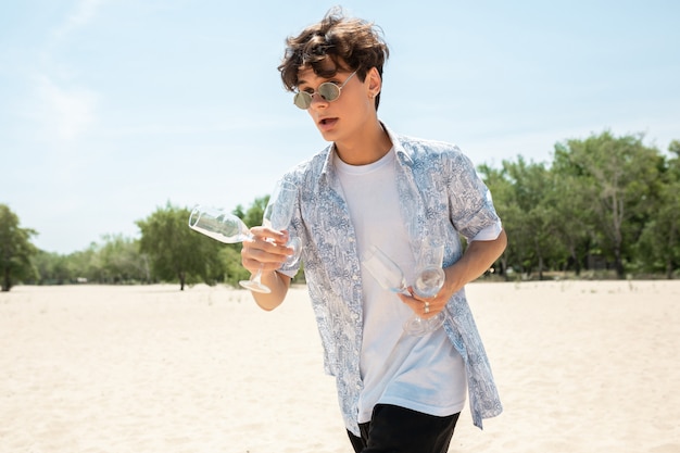 Young man with sunglasses and champagne bottle