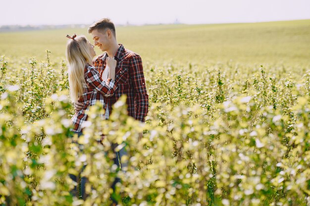 Young man and woman couple in a summer field