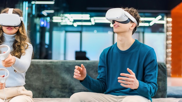 A young man and woman exploring virtual reality in an office