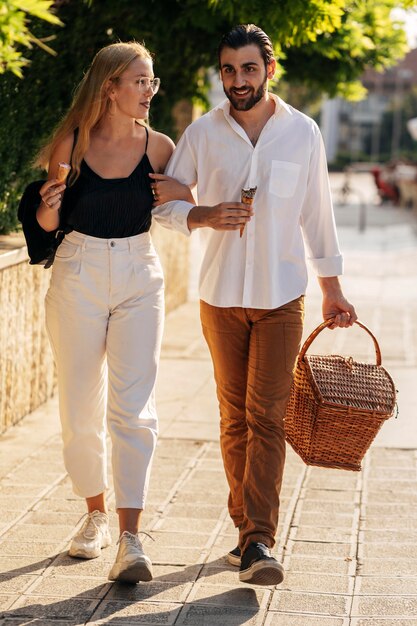 Young man and woman going to the park to have a picnic