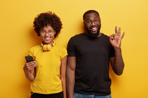 Young man and woman holding phone