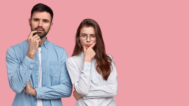 Young man and woman in shirts posing