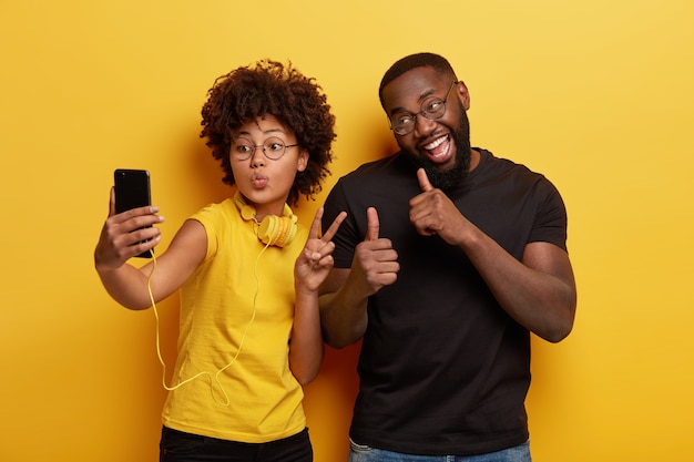 Young man and woman taking selfie