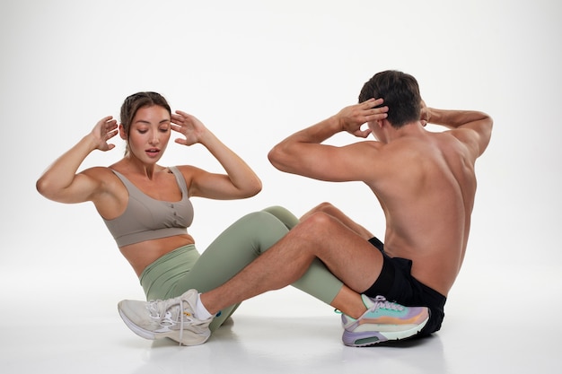 Young man and woman training together for bodybuilding