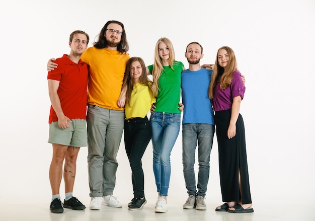 Free Photo young man and woman weared in lgbt flag colors on white background. caucasian models in bright shirts.