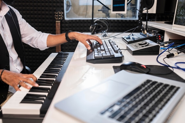 Young man working at a radio station with special equipment