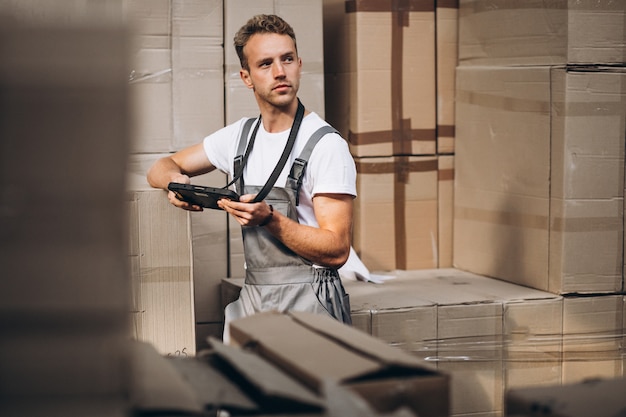 Free Photo young man working at a warehouse with boxes