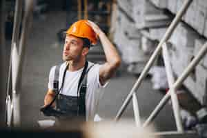 Free photo young man working at a warehouse with boxes