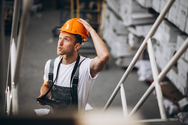 Free Photo young man working at a warehouse with boxes