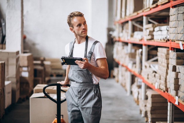 Free Photo young man working at a warehouse with boxes