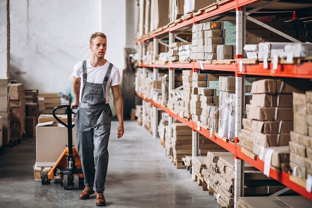 Young man working at a warehouse with boxes