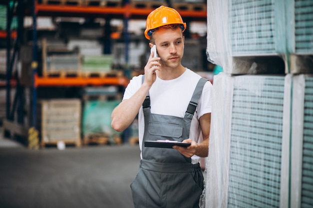 Young man working at a warehouse with boxes