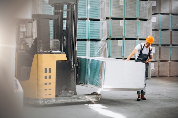 Young man working at a warehouse with boxes