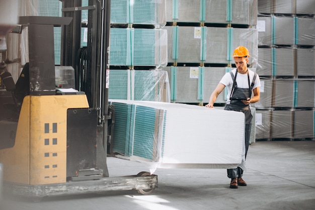 Young man working at a warehouse with boxes