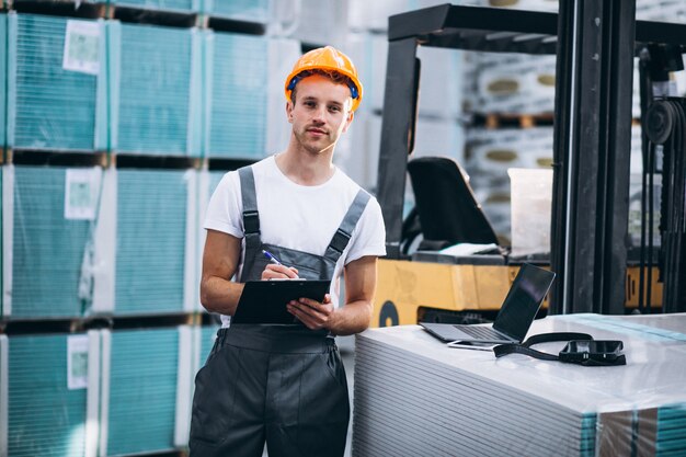 Young man working at a warehouse with boxes