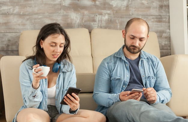 Young married couple relaxing in living room