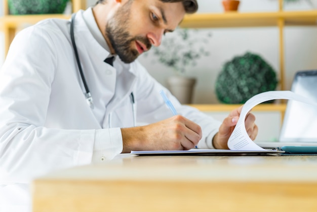 Free photo young medical practitioner making notes