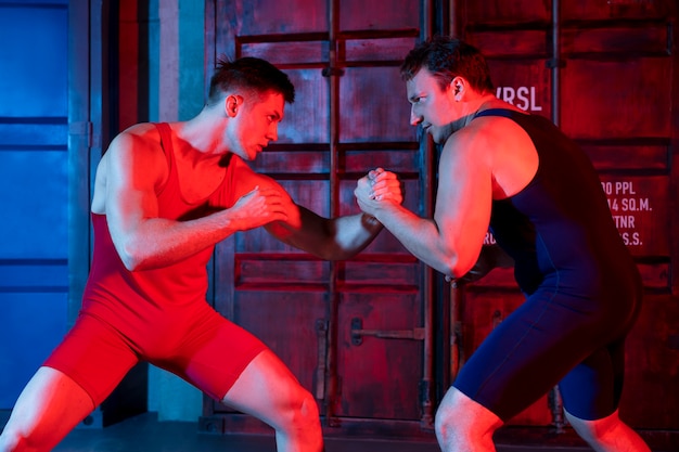 Free photo young men in sportswear wrestling each other