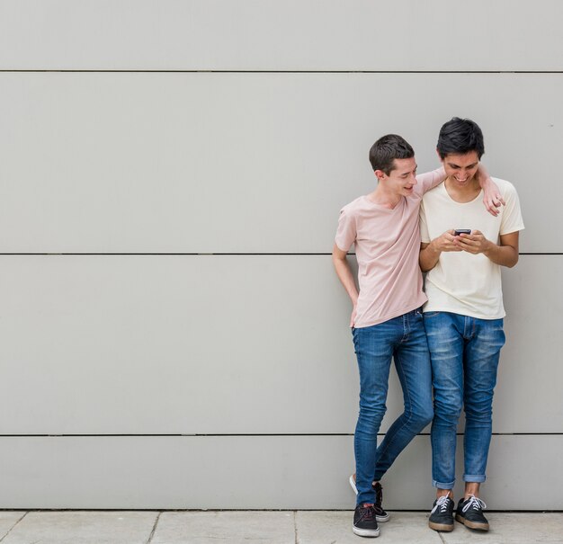 Young men together browsing a phone