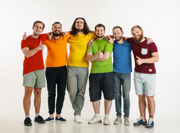 Free Photo young men weared in lgbt flag colors isolated on white wall