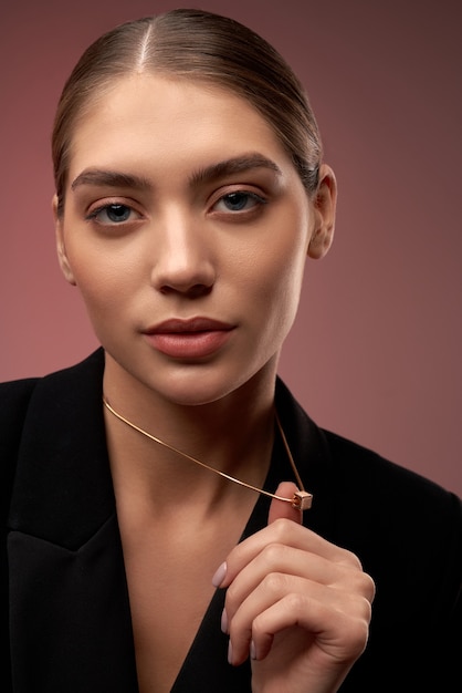 Young model demonstrating golden necklace