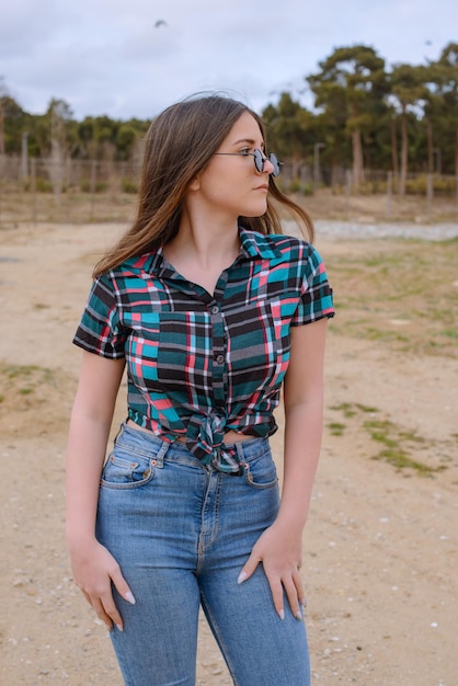 Free photo young model stands on at the yard