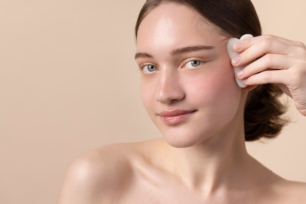 Young model using gua sha side view