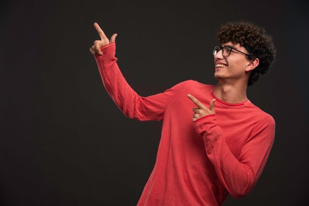 Young model with curly hairs promoting something . 