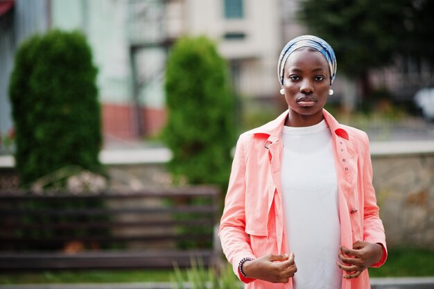 Young modern fashionable attractive tall and slim african muslim woman in hijab or turban head scarf posed