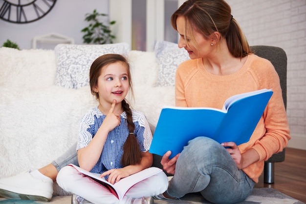 Young mom helping her daughter with homework