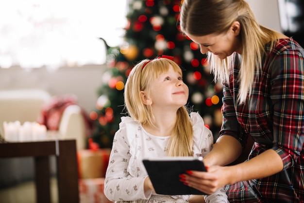 Young mother and daughter celebrating christmas