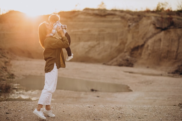 Young mother having fun with her little son