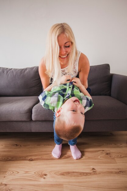 Young mother playing with her son