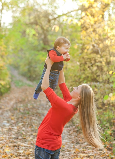 Young mother raising cute little baby