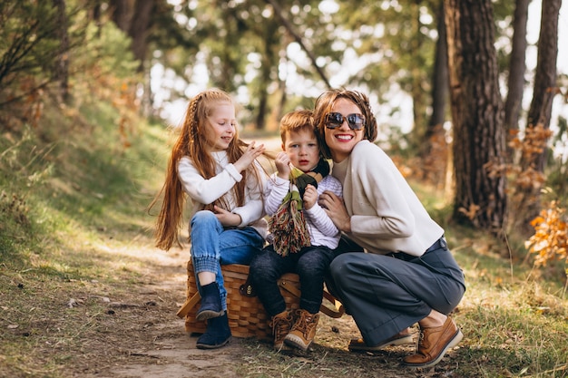 Young mother with daughter and son in forest