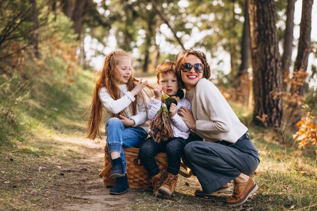 Young mother with daughter and son in forest