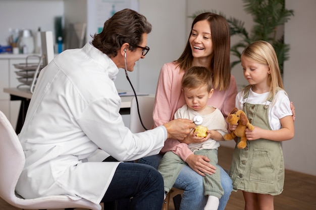 Young mother with her children at a pediatrician appointment