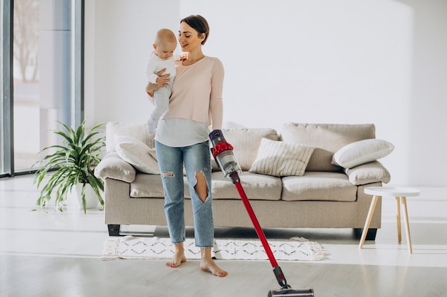 Free photo young mother with toddler son cleaning up at home