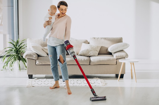 Free photo young mother with toddler son cleaning up at home