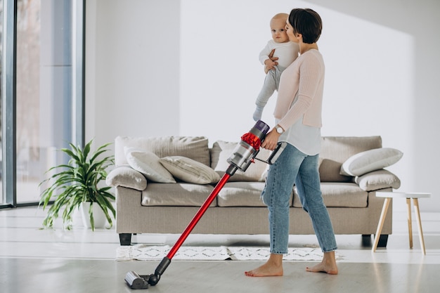 Young mother with toddler son cleaning up at home