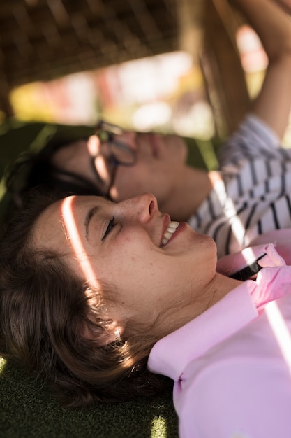 Young multiethnic couple lying on shadow with light gleams