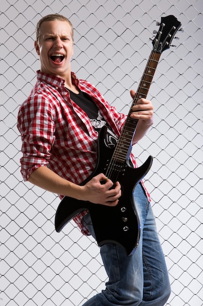 Free photo young musician with a guitar