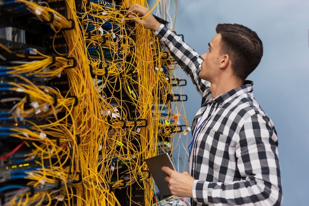 Free Photo young network engineer working in a server room