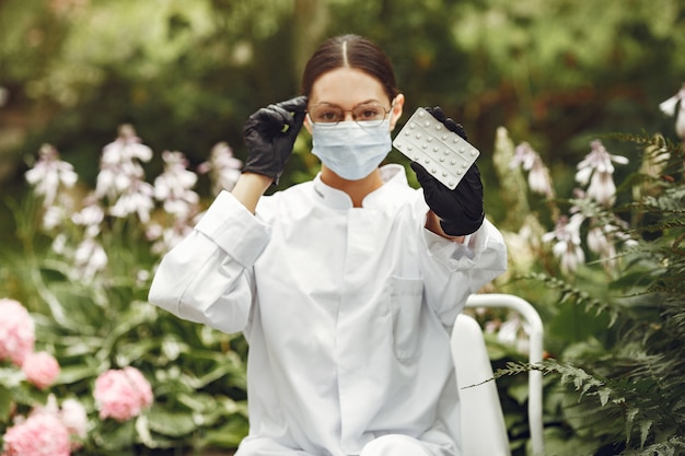 Young nurse in outdoor. Woman doctor. Doctor with pills in her hands.