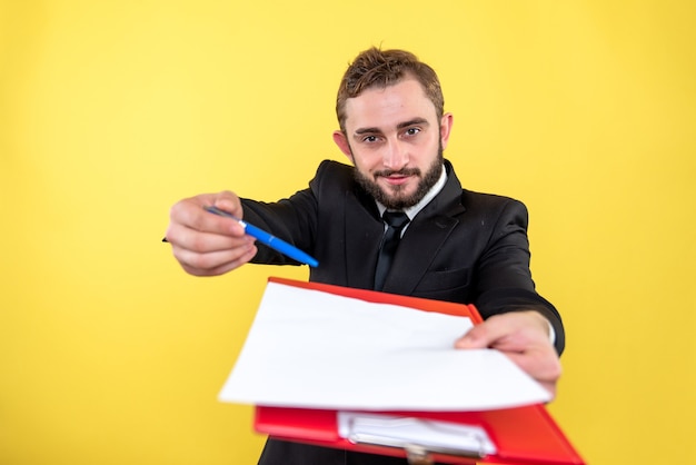 Free photo young office assistant asking for signing the document on yellow