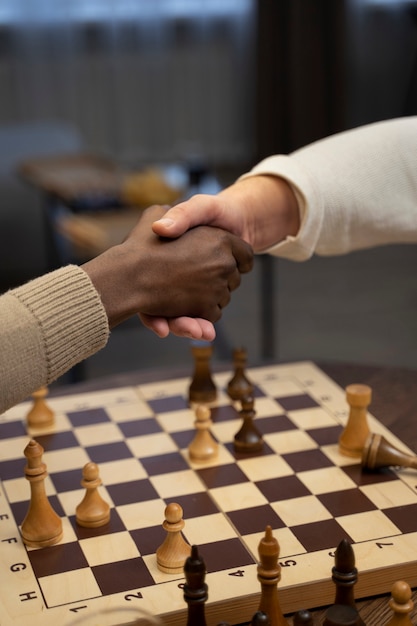 Young and old men shaking hands side view